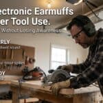 Man using electronic earmuffs for power tool safety in workshop.