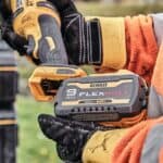 Person holding DeWalt 20V FLEXVOLT battery for power tools.